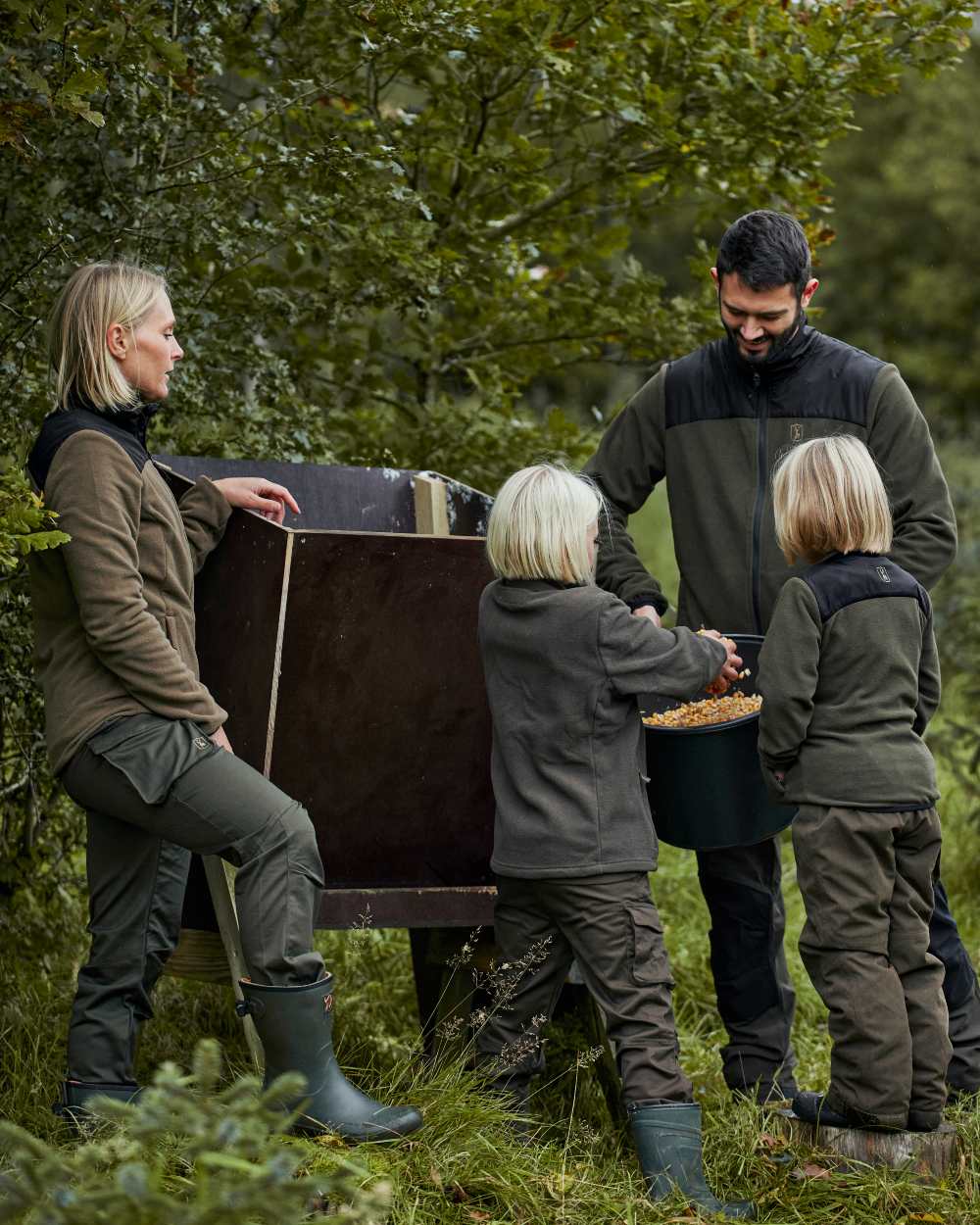 Tarmac Green coloured Deerhunter Youth Eagle Winter Trousers on forest background #colour_tarmac-green