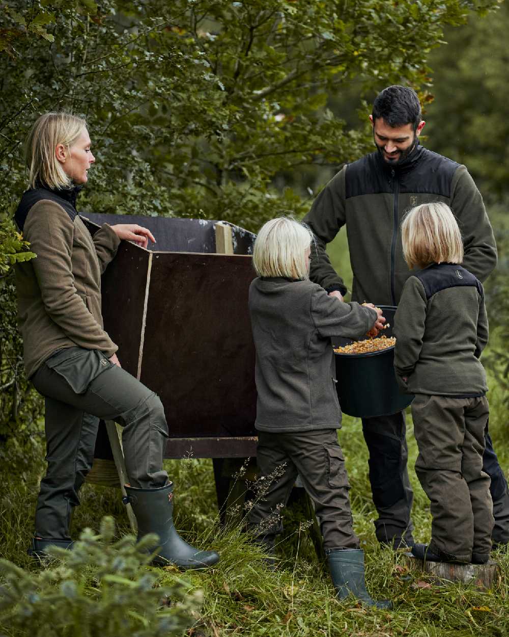 Chestnut Brown coloured Deerhunter Youth Traveler Trousers on forest background #colour_chestnut-brown