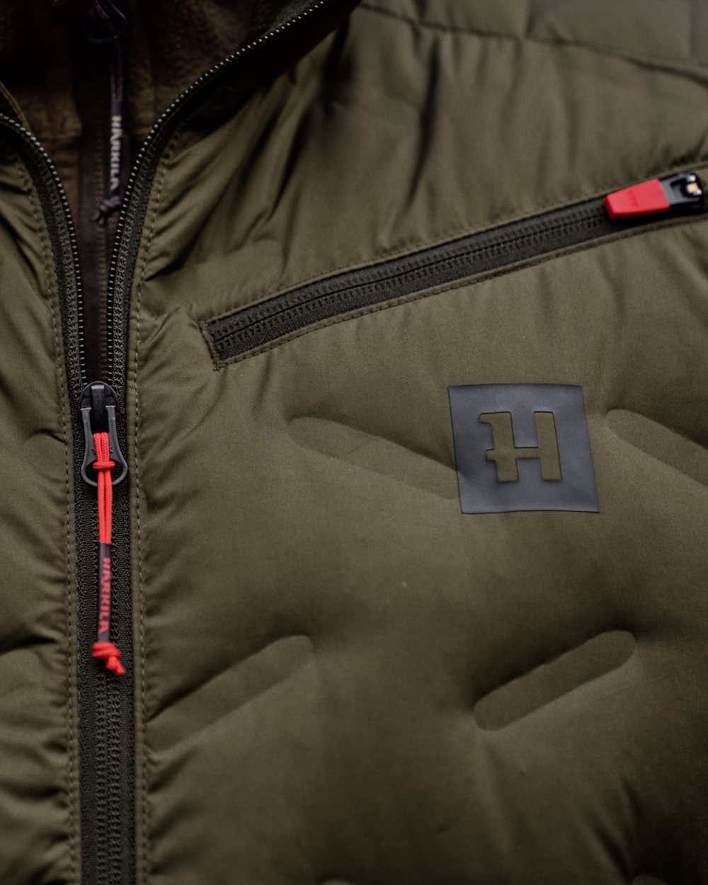 Willow Green Coloured Harkila Clim8 Insulated Waistcoat on outdoor background #colour_willow-green