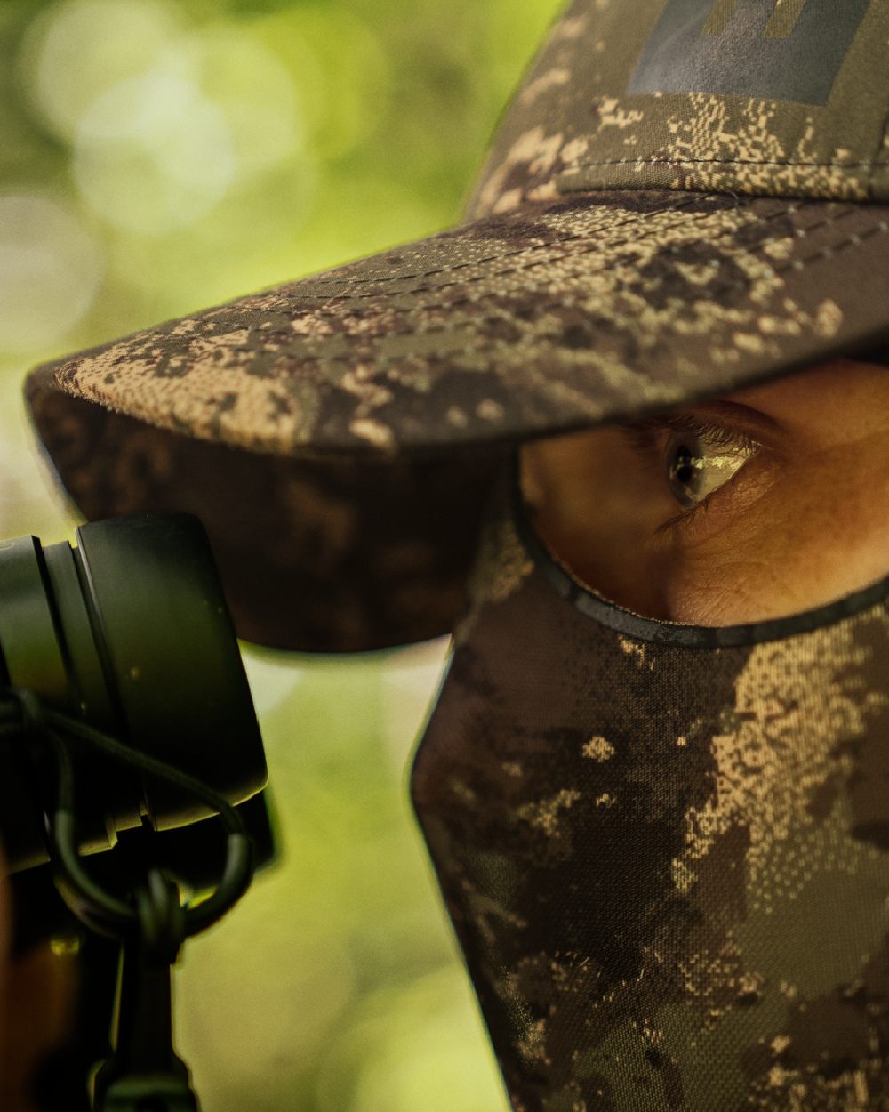 AXIS Forest Coloured Harkila Deer Stalker Camo Cap With Mesh on blurry background #colour_axis-forest