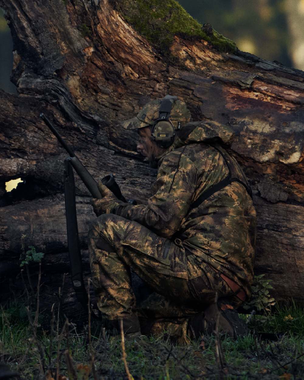 AXIS Forest Coloured Harkila Deer Stalker Camo HWS Jacket on forest background #colour_axis-forest