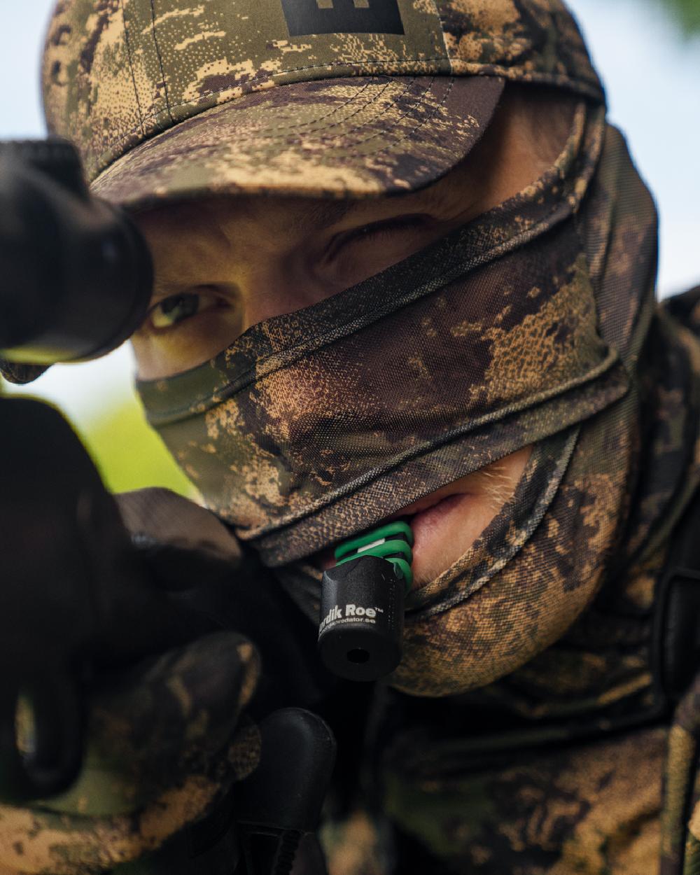AXIS Forest Coloured Harkila Deer Stalker Camo Mesh Face Cover on blurry background #colour_axis-forest