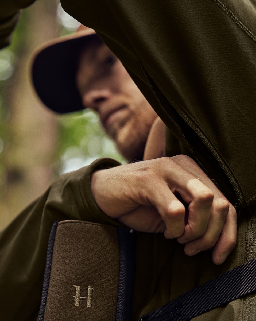 Willow Green Shadow Brown Coloured Harkila Deer Stalker Fleece Hoodie on outdoor background #colour_willow-green-shadow-brown