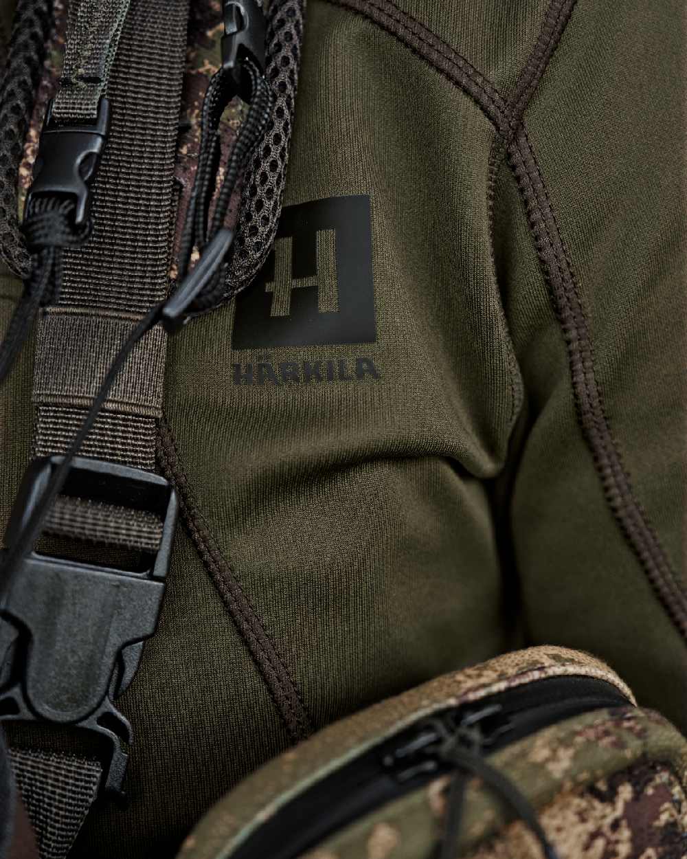 Willow Green Coloured Harkila Deer Stalker Full Zip Fleece Hoodie on blurry background #colour_willow-green