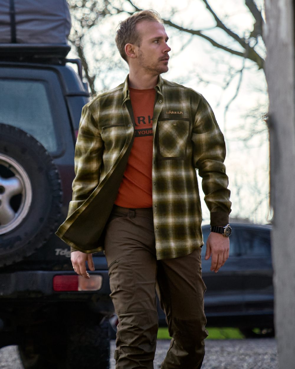 Willow Green Coloured Harkila Folke Shirt Jacket on countryside background #colour_willow-green
