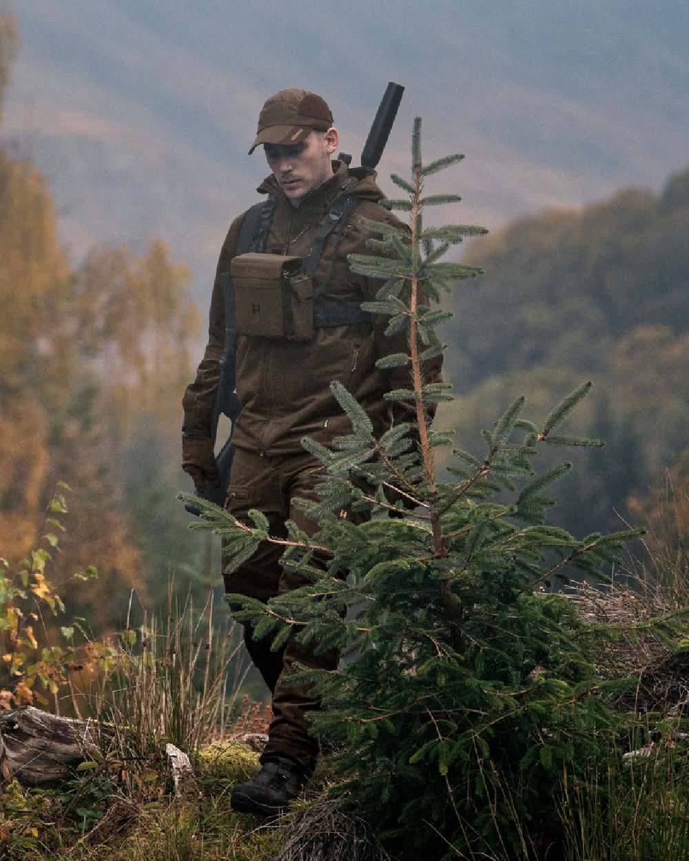 Hunting Green Shadow Brown Coloured Harkila Forest Hunter GTX Jacket on outdoor background #colour_hunting-green-shadow-brown