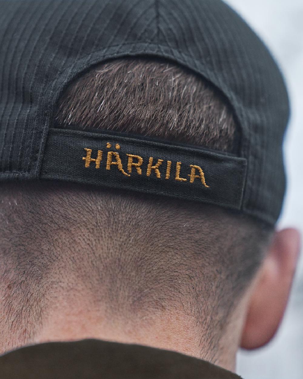Dark Navy Coloured Harkila Instinct Cap on blurry background #colour_dark-navy