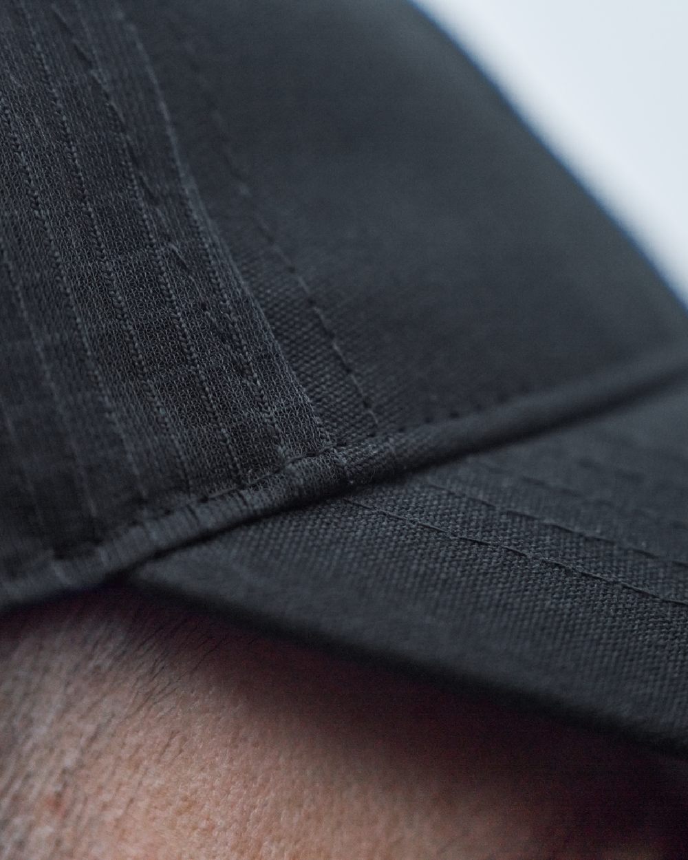 Dark Navy Coloured Harkila Instinct Cap on blurry background #colour_dark-navy