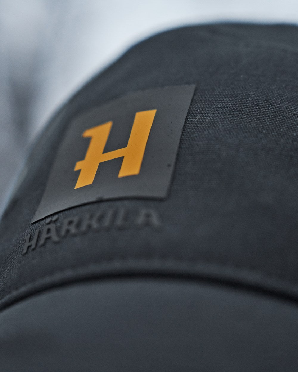 Dark Navy Coloured Harkila Instinct Cap on blurry background #colour_dark-navy