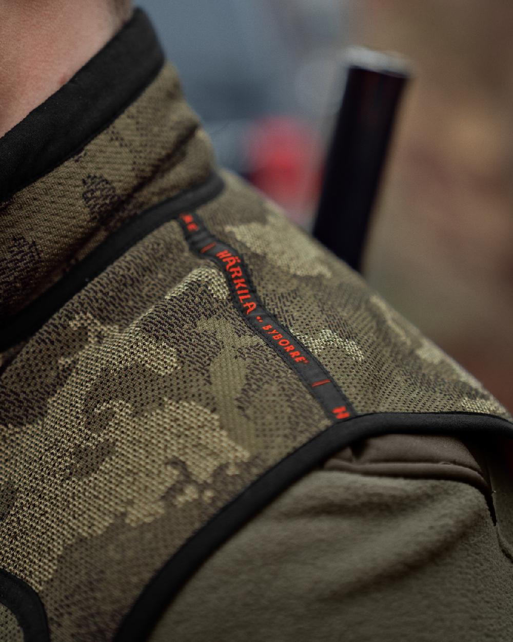 AXIS Limited Edition Orange Coloured Harkila Kamko Pro Edition Reversible Hi-Vis Waistcoat on forest background #colour_axis-limited-edition-orange