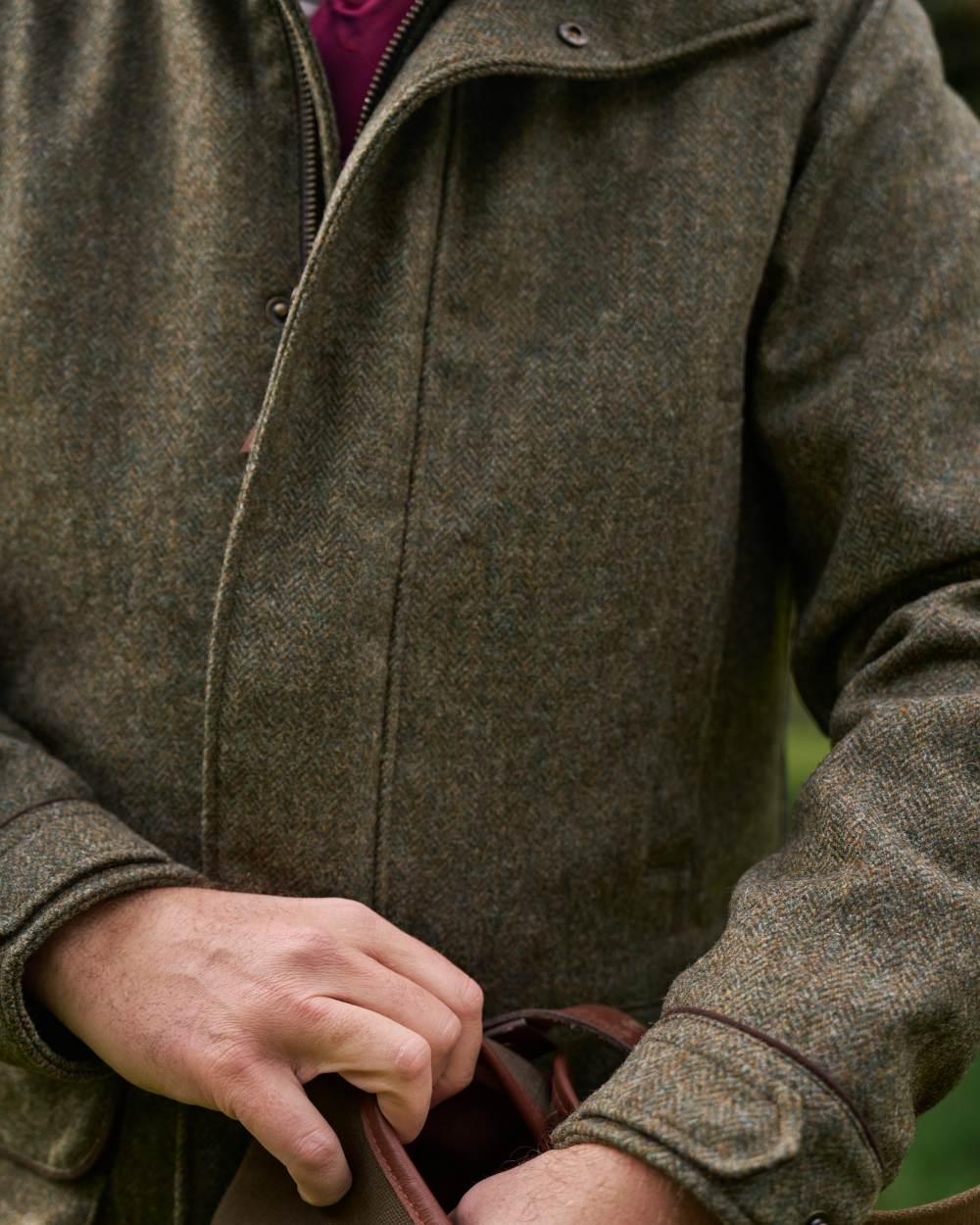 Forest Green Herringbone Coloured Harkila Kenmore GTX Jacket on forest background #colour_forest-green-herringbone