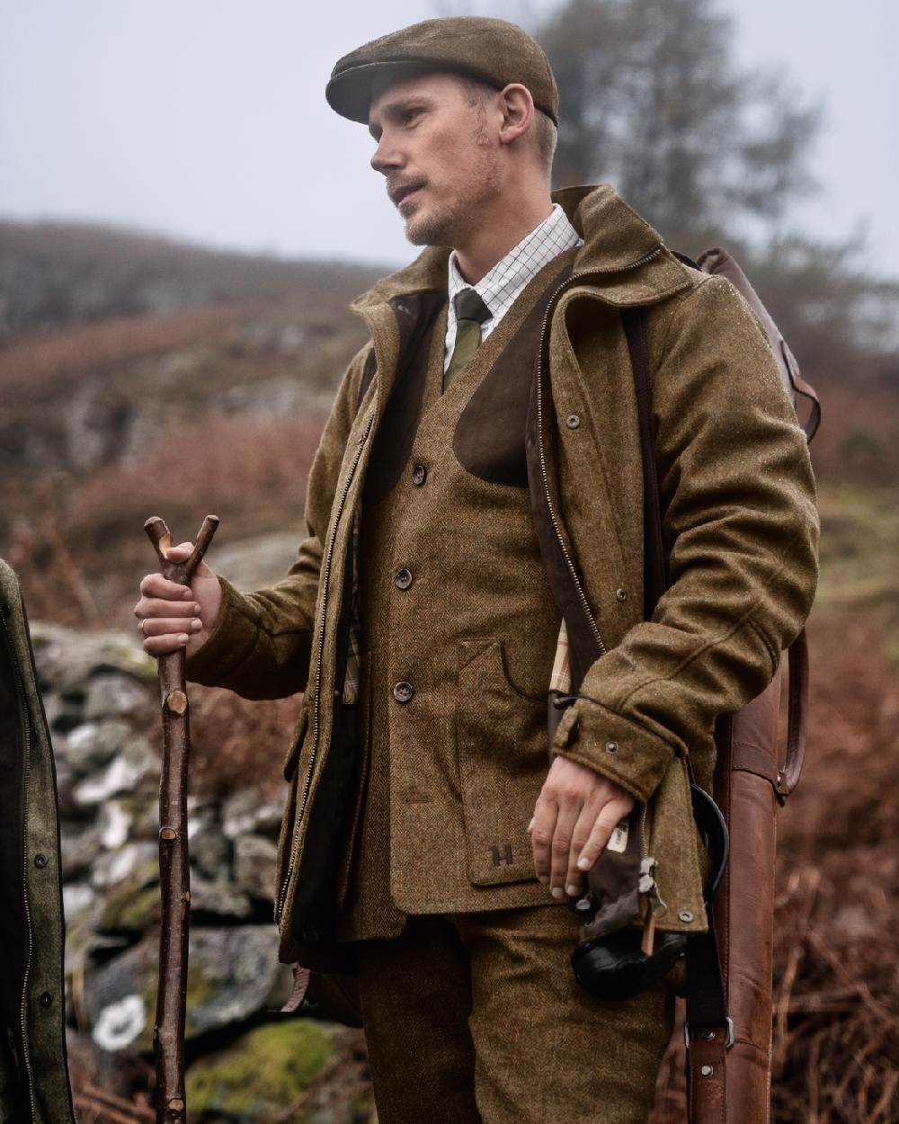 Terragon Brown Coloured Harkila Kenmore Shooting Waistcoat on forest background #colour_terragon-brown