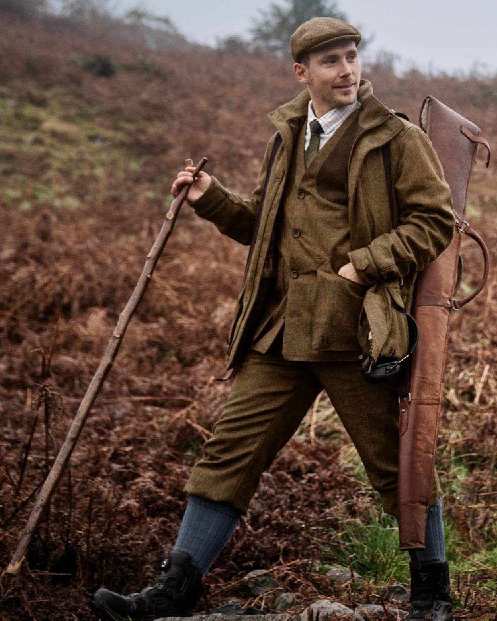 Terragon Brown Coloured Harkila Kenmore Shooting Waistcoat on forest background #colour_terragon-brown