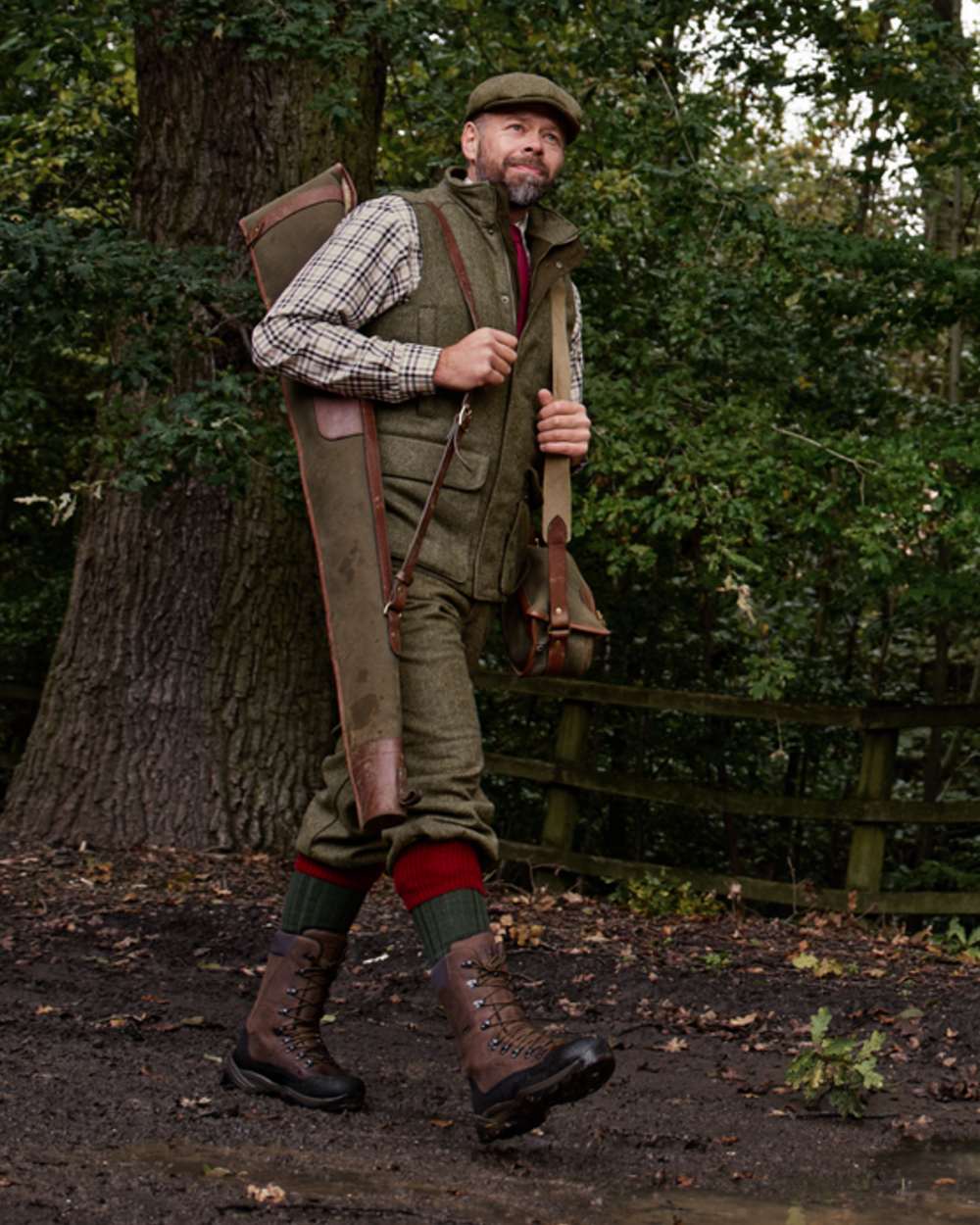 Forest Green Herringbone Coloured Harkila Kenmore Waistcoat on forest background #colour_forest-green-herringbone