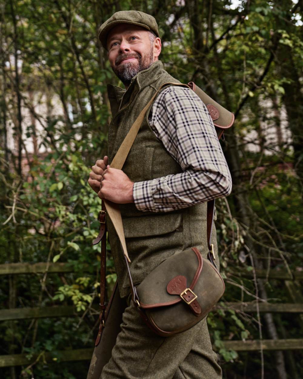 Forest Green Herringbone Coloured Harkila Kenmore Waistcoat on forest background #colour_forest-green-herringbone
