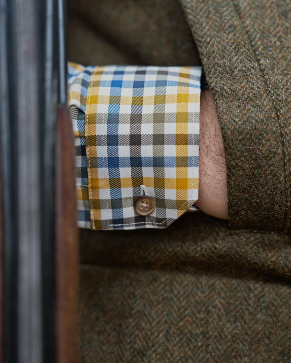 Forest Green Herringbone Coloured Harkila Kenmore Waistcoat on forest background #colour_forest-green-herringbone