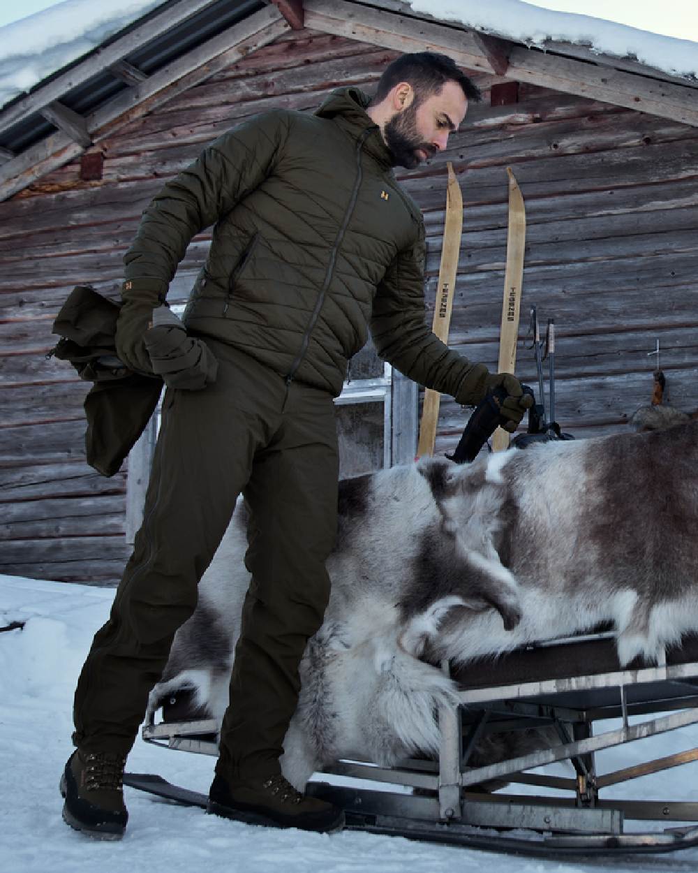 Willow Green Coloured Harkila Logmar Insulated Packable Hooded Jacket on snow background #colour_willow-green