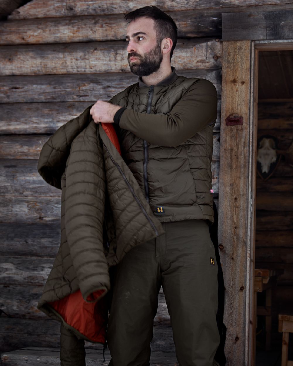 Willow Green Coloured Harkila Logmar Insulated Packable Waistcoat on outdoor background #colour_willow-green