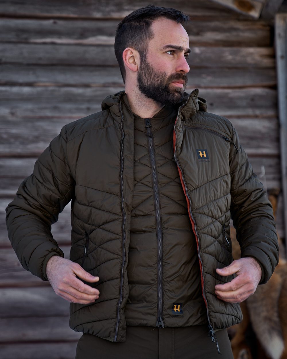 Willow Green Coloured Harkila Logmar Insulated Packable Waistcoat on outdoor background #colour_willow-green