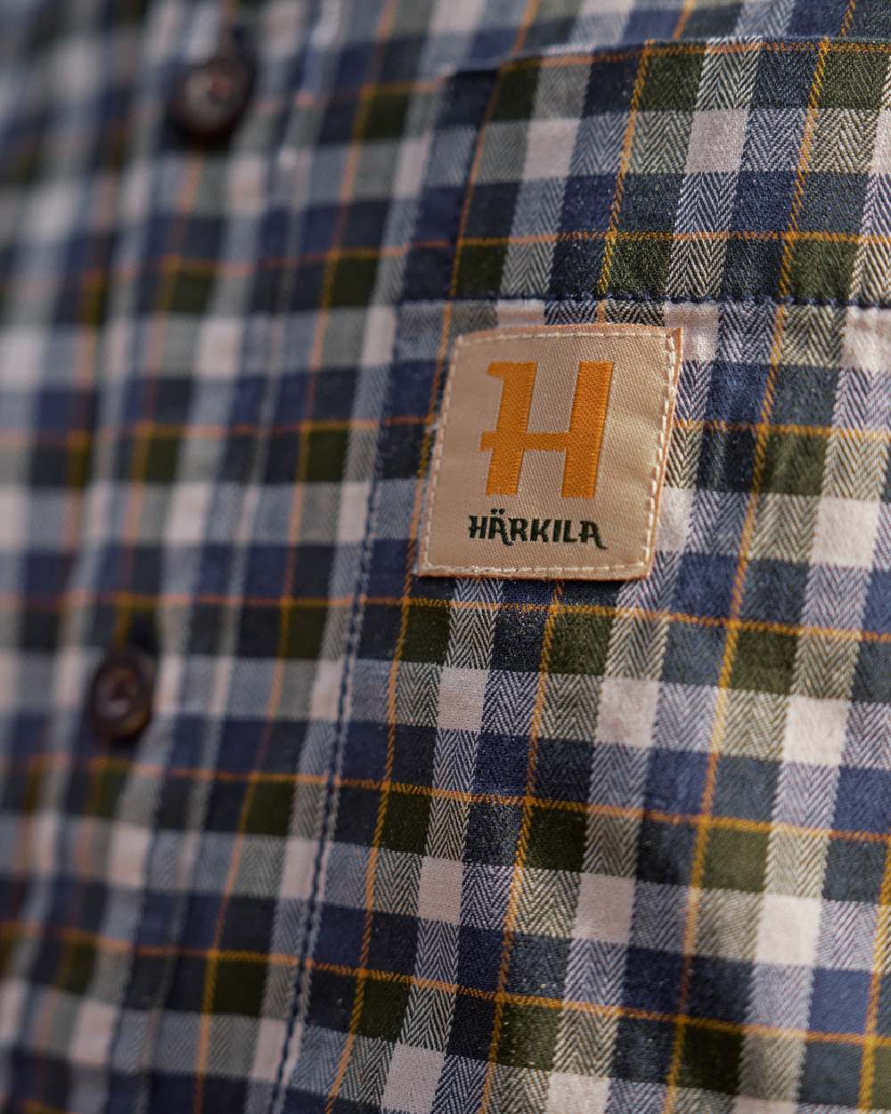 Naval Blue Check Coloured Harkila Mens Fjell Short Sleeve Shirt on blurry background #colour_naval-blue-check