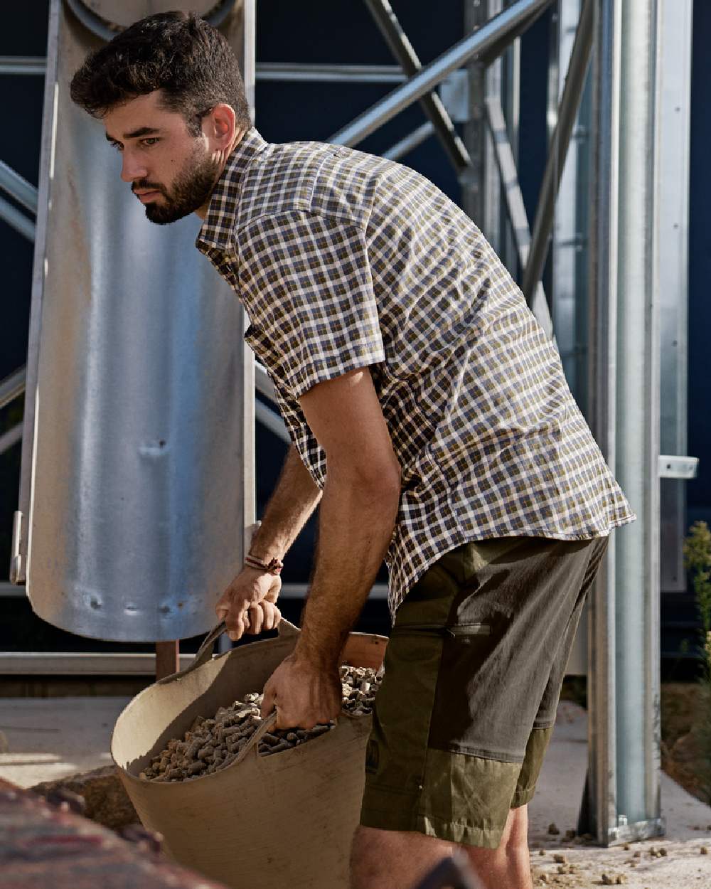 Dark Olive Willow Green Coloured Harkila Mens Fjell Shorts on construction background #colour_dark-olive-willow-green