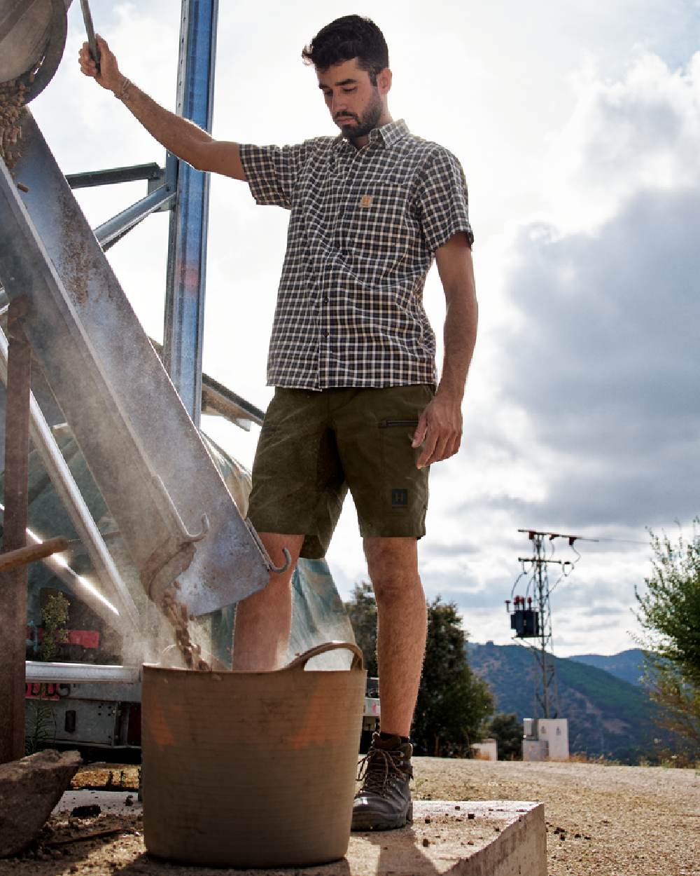 Dark Olive Willow Green Coloured Harkila Mens Fjell Shorts on construction background #colour_dark-olive-willow-green