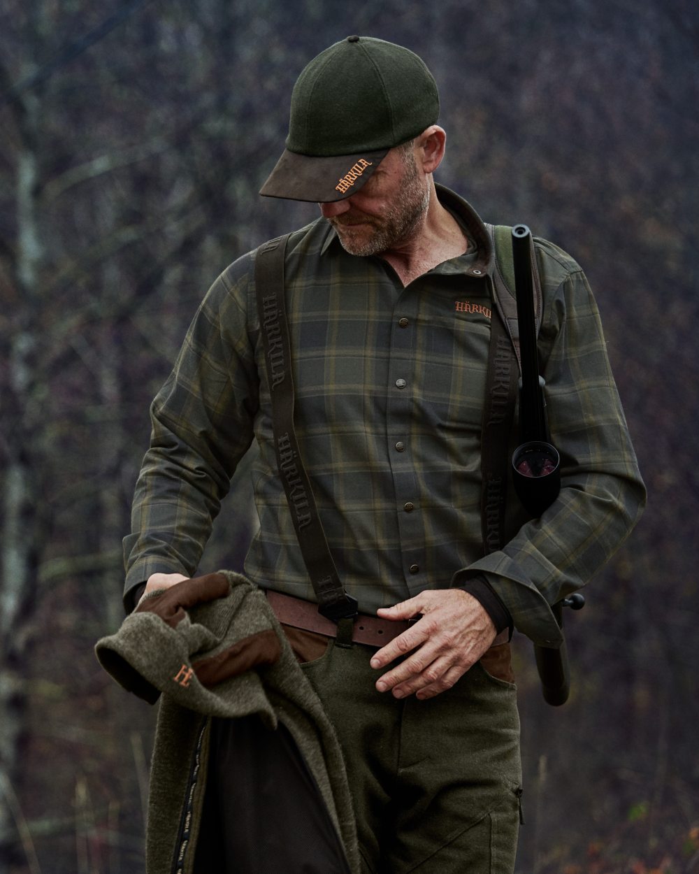 Willow Green Check colour Harkila Metso Active Shirt on blurry background #colour_willow-green-check