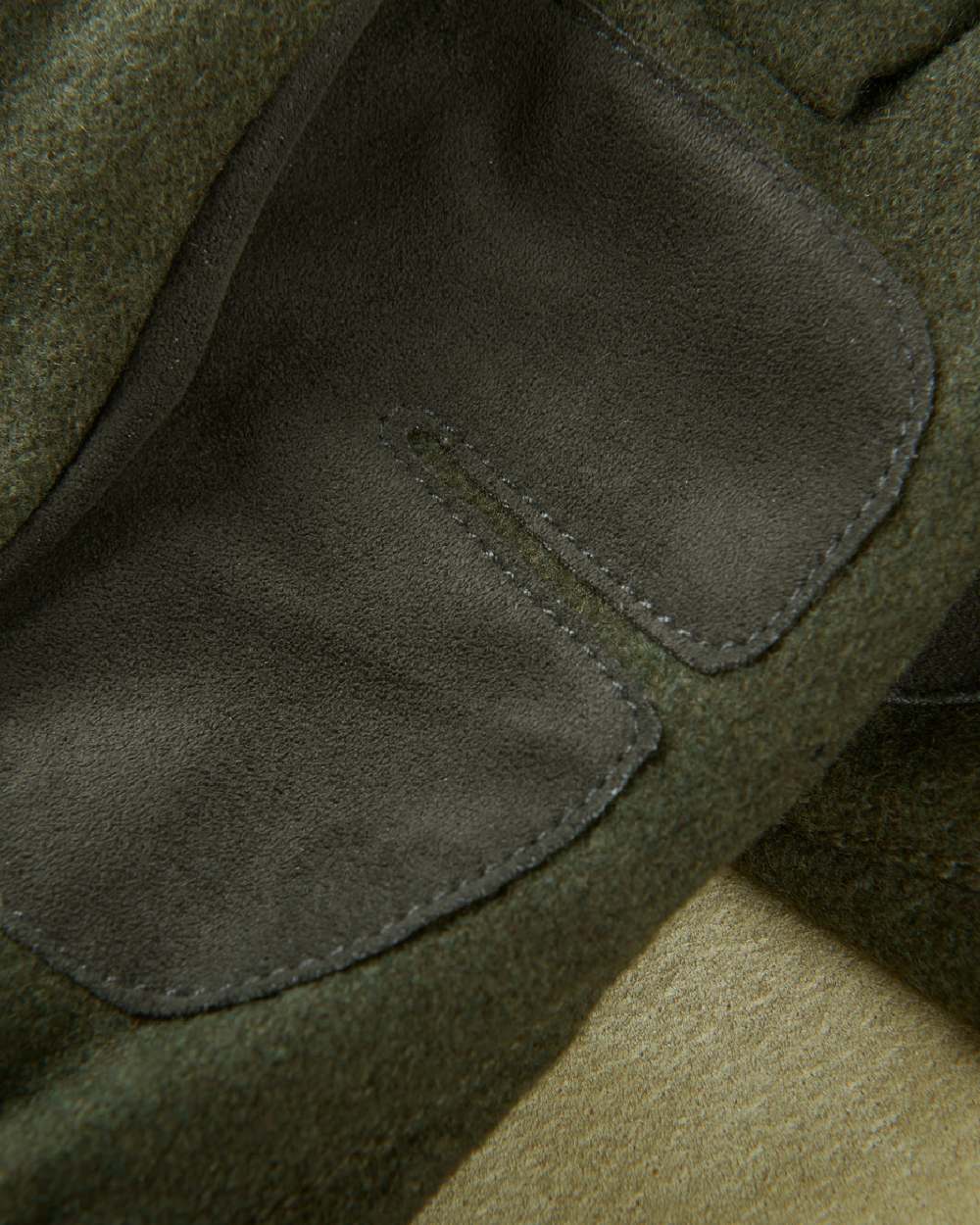 Willow Green Coloured Harkila Metso Active Gloves on blurry background #colour_willow-green