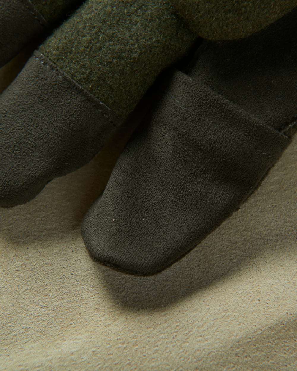 Willow Green Coloured Harkila Metso Active Gloves on blurry background #colour_willow-green