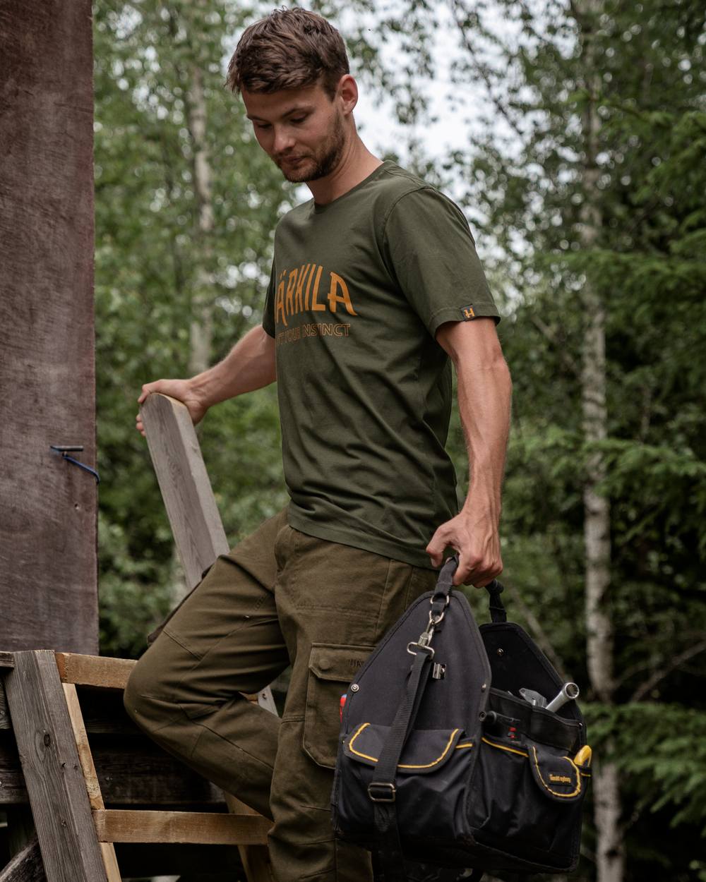 Rosin Coloured Harkila Modi Short Sleeve T-Shirt on forest background #colour_rosin
