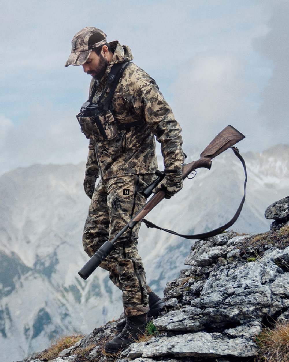 AXIS Mountain Coloured Harkila Mountain Hunter Expedition HWS Packable Jacket on outdoor background #colour_axis-mountain