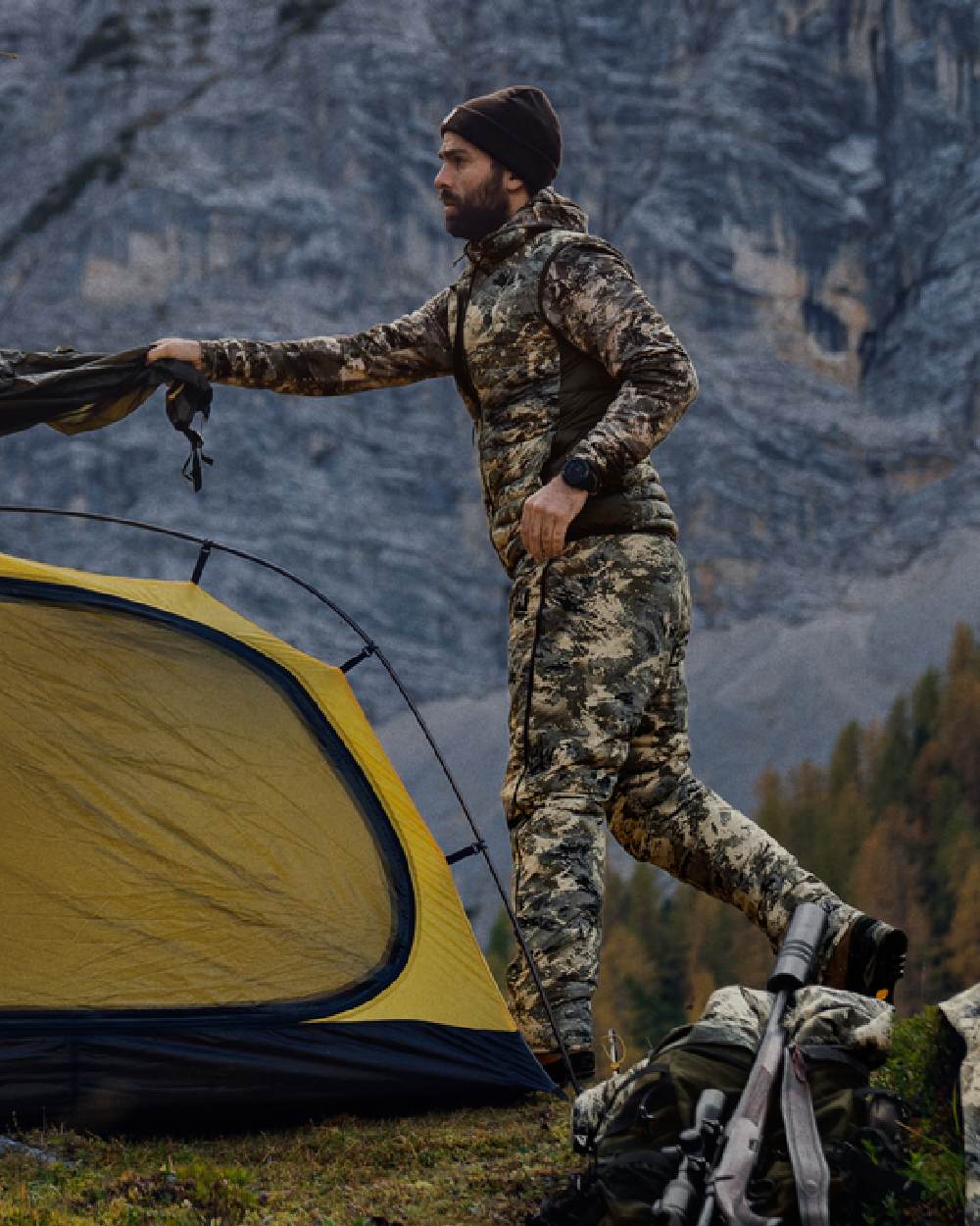 AXIS Mountain Shadow Brown Coloured Harkila Mountain Hunter Expedition Reversible Down Waistcoat on mountain background #colour_axis-mountain-shadow-brown