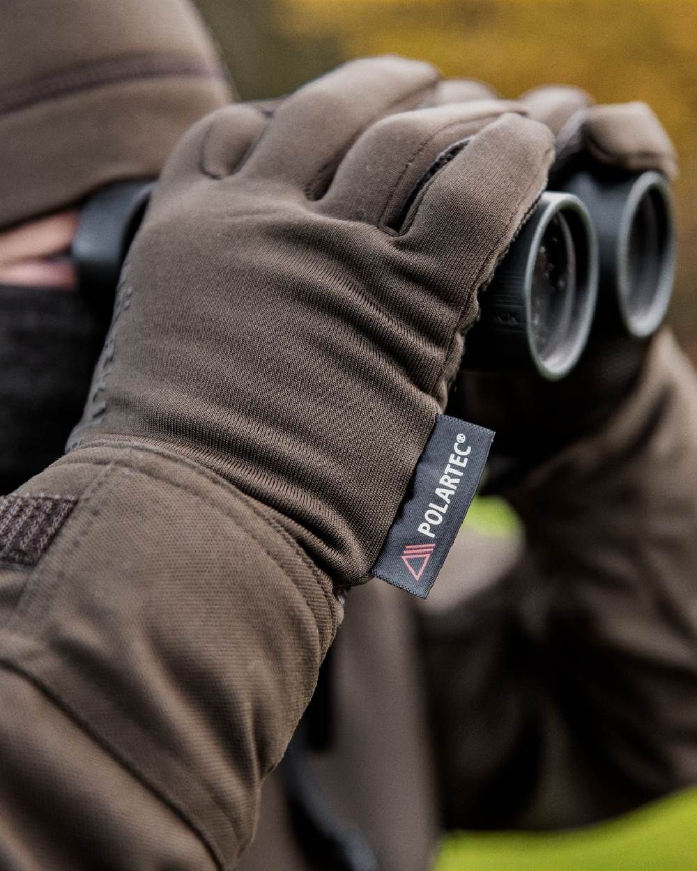 Shadow Brown Coloured Harkila Power Stretch Gloves on outdoor background #colour_shadow-brown