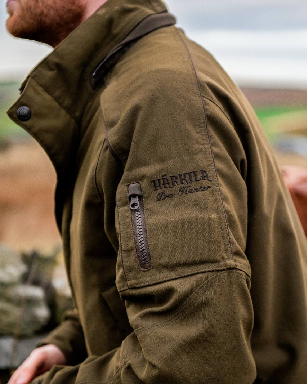 Willow Green Coloured Harkila Pro Hunter Endure Jacket on outdoor background #colour_willow-green