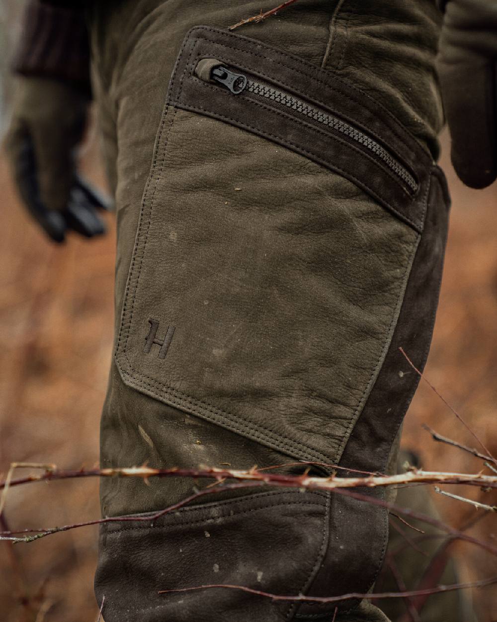 Willow Green Coloured Harkila Pro Hunter Leather Trousers on outdoor background #colour_willow-green