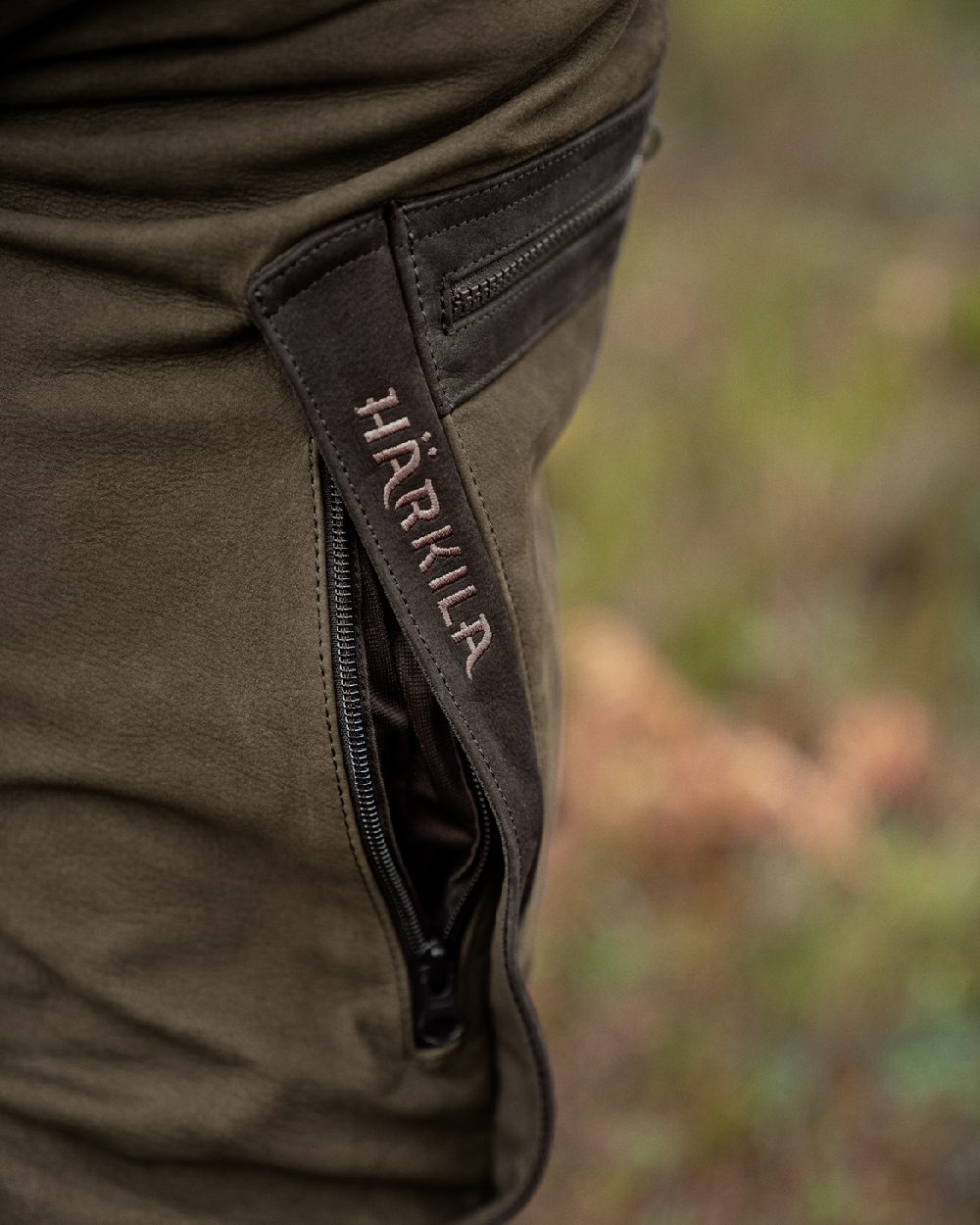 Willow Green Coloured Harkila Pro Hunter Leather Trousers on outdoor background #colour_willow-green
