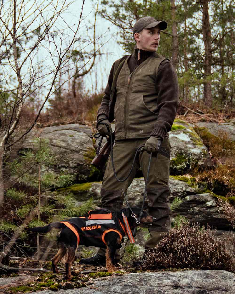 Willow Green Coloured Harkila Pro Hunter Leather Waistcoat on forest background #colour_willow-green