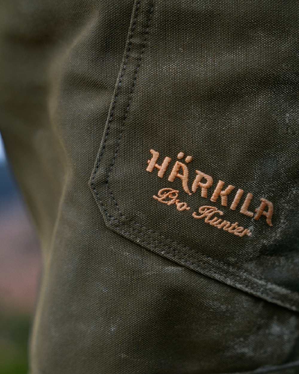 Willow Green Coloured Harkila Pro Hunter Move Trousers on outdoor background #colour_willow-green