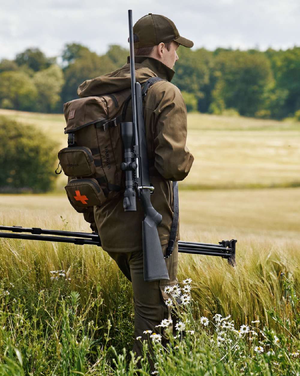 Willow Green Coloured Harkila Ragnar First Aid Backpack on forest background #colour_willow-green