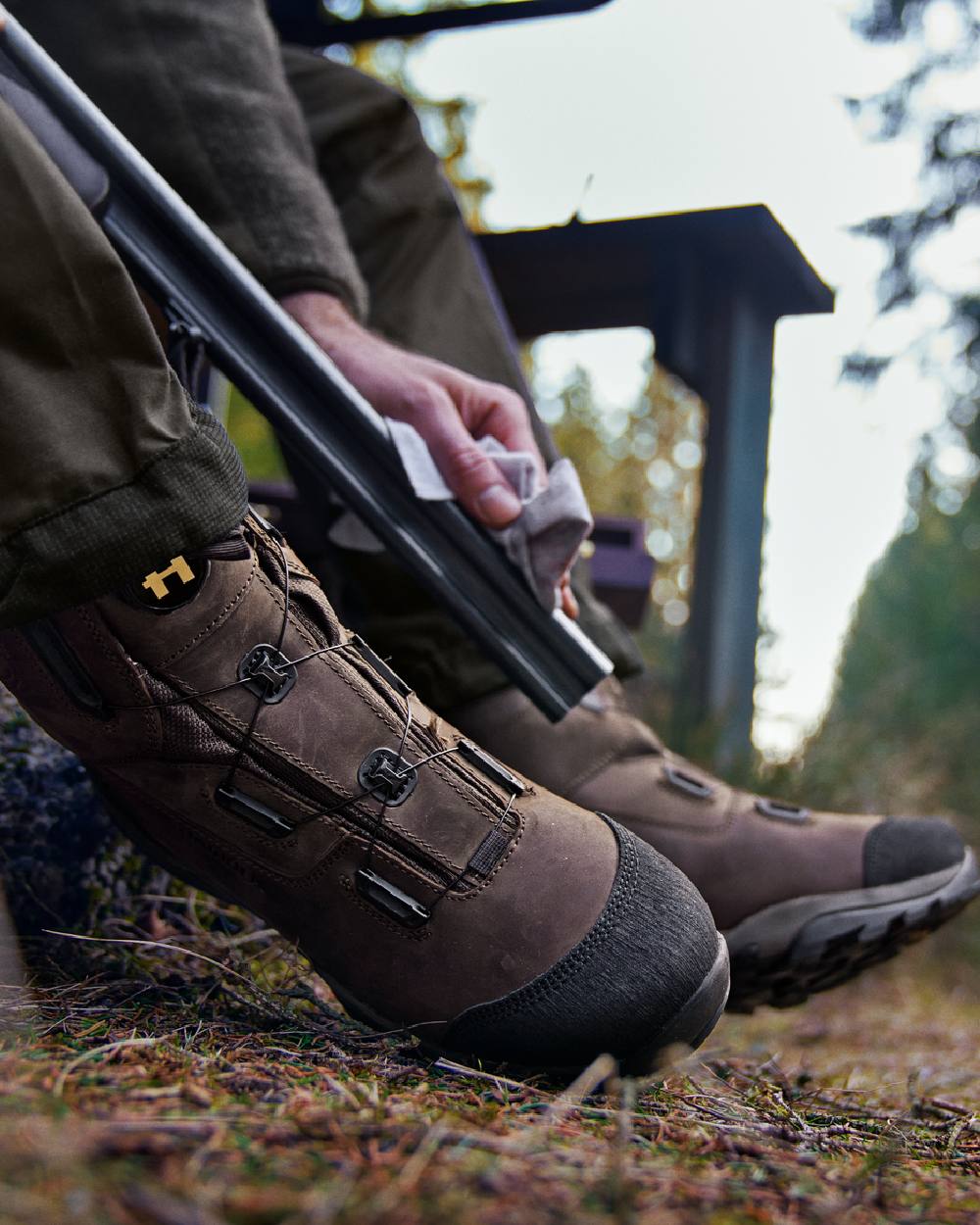 Dark Brown Coloured Harkila Reidmar Mid 2.0 GTX Leather Boots on outdoor background #colour_dark-brown