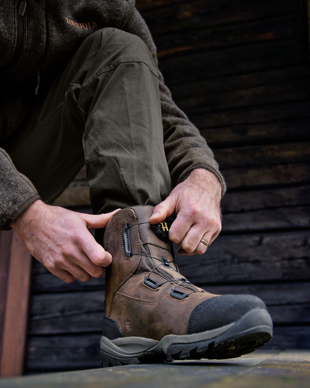 Dark Brown Coloured Harkila Reidmar Mid 2.0 GTX Leather Boots on outdoor background #colour_dark-brown