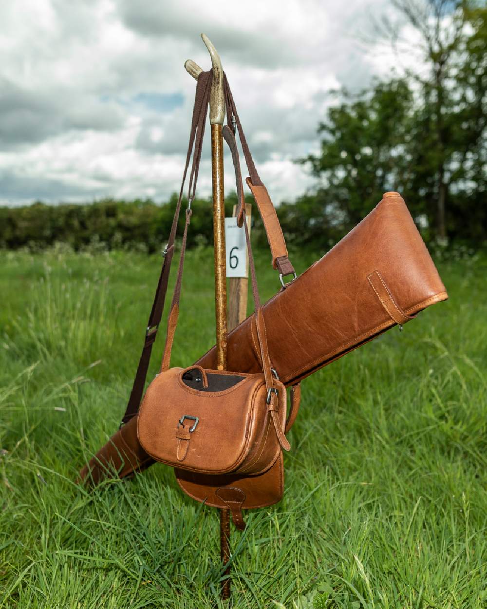 Cognac Coloured Harkila Retrieve Cartridge Bag 125 Cartridges on forest background #colour_cognac