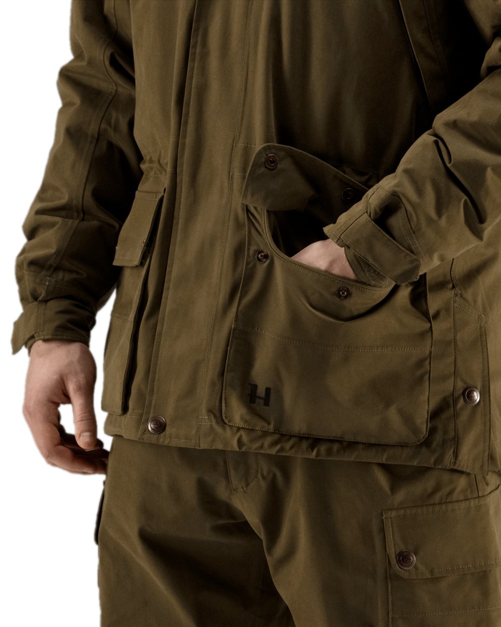 Warm Olive Coloured Harkila Retrieve Jacket on white background #colour_warm-olive