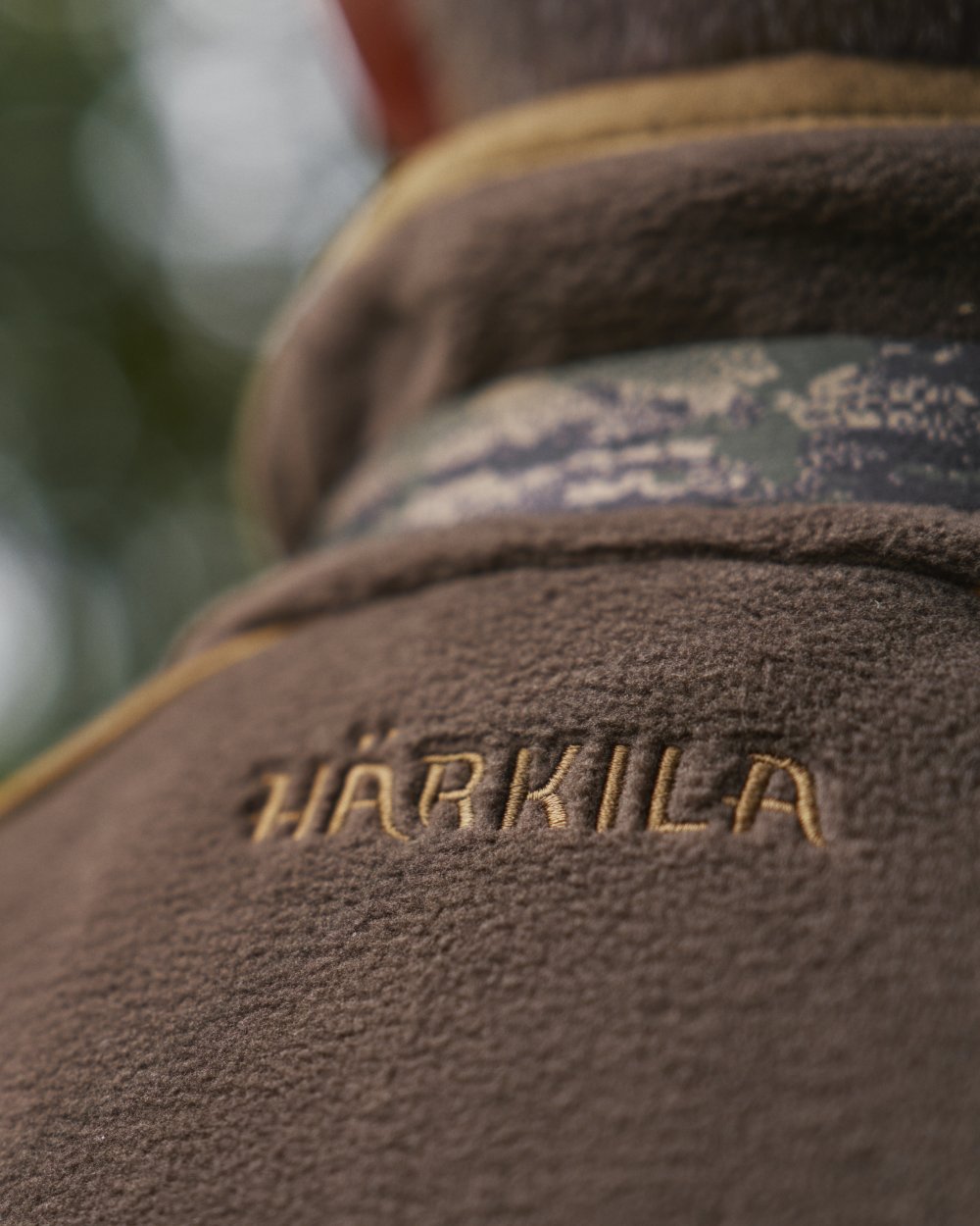 Demitasse Brown Coloured Harkila Sandhem 200 Fleece Waistcoat on forest background #colour_demitasse-brown