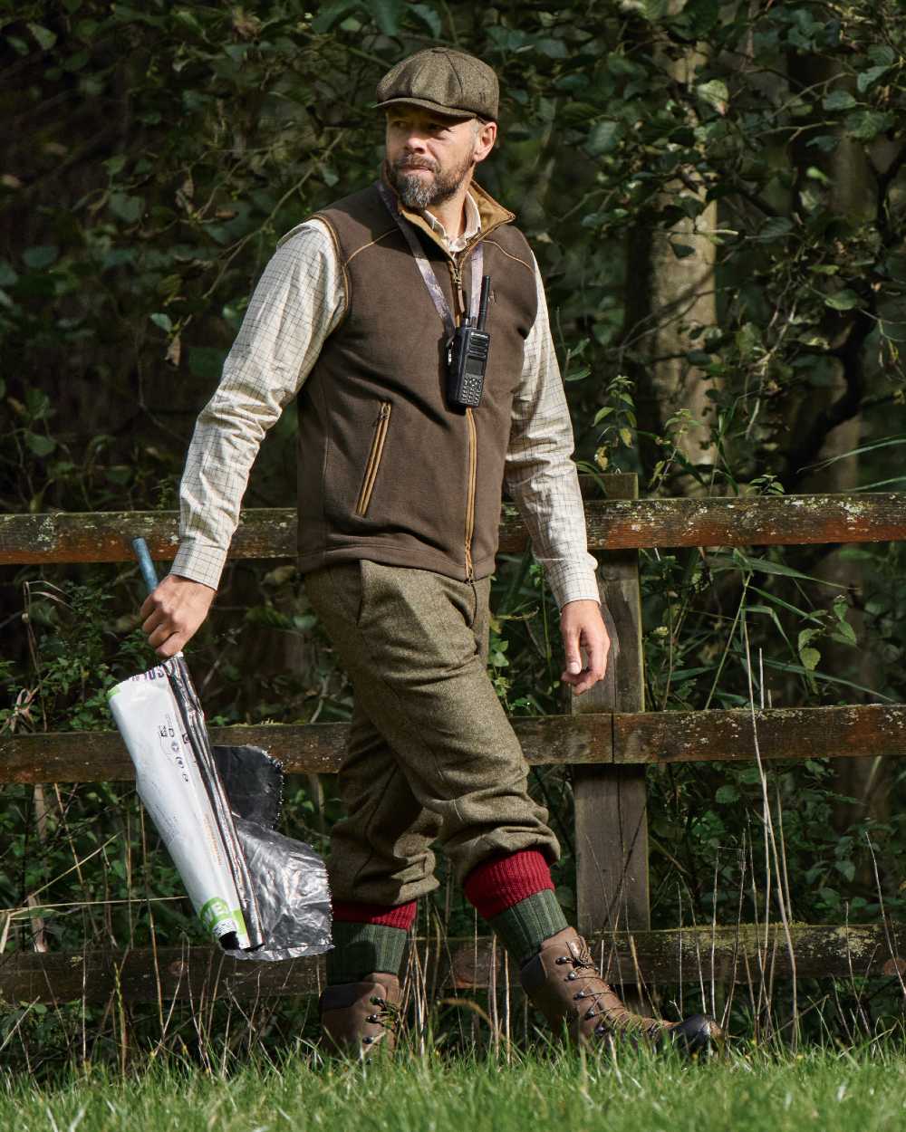 Demitasse Brown Coloured Harkila Sandhem 200 Fleece Waistcoat on forest background #colour_demitasse-brown