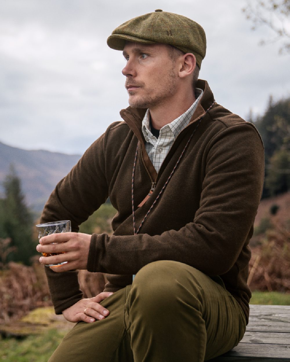 Willow Green coloured Harkila Sandhem Pro HSP Pullover on forest background #colour_willow-green
