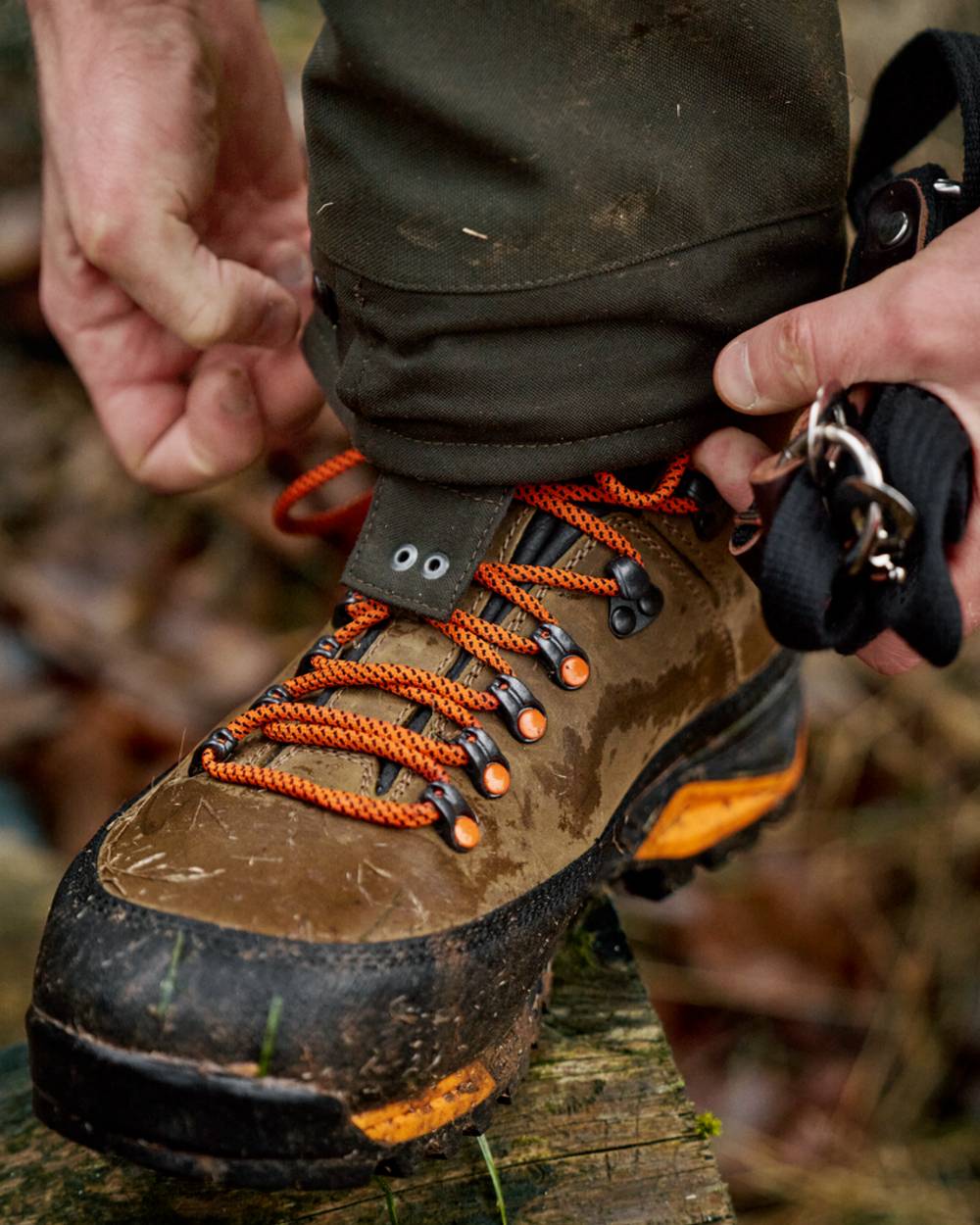 Mid Brown Orange Coloured Harkila Saxnas GTX Boots on mud background #colour_mid-brown-orange