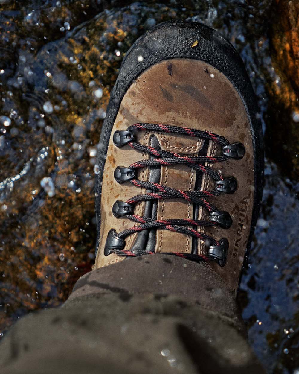Mid Brown Coloured Harkila Saxnas GTX Boots on water background #colour_mid-brown