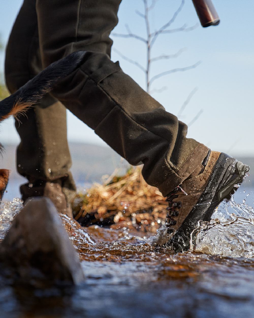 Mid Brown Coloured Harkila Saxnas GTX Boots on water background #colour_mid-brown