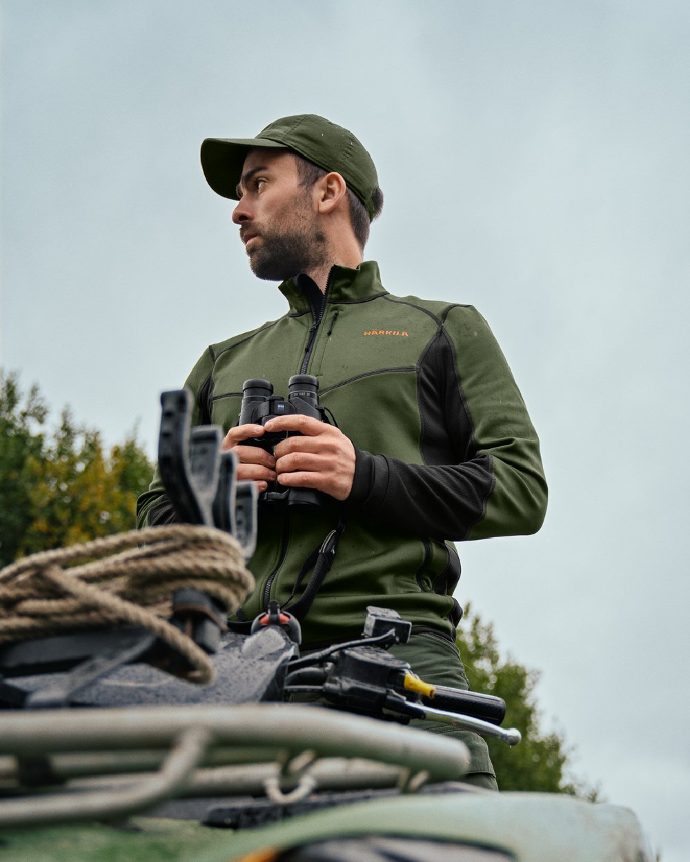 Duffel Green Black Coloured Harkila Scandinavian Fleece Jacket on outdoor background #colour_duffel-green-black
